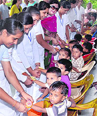 Students of the St Soldier Nursing Training Institute tie rakhis on the hands of inmates of Pingla Ghar in Jalandhar on Wednesday