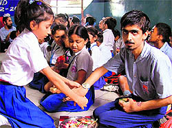 A girl ties a rakhi on the wrist of a differently abled boy at Rotary Bhawan in Ludhiana on Wednesday
