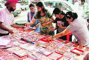 Women choose rakhis in a market in Ludhiana on Wednesday