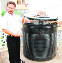 Dr Ravi Chand Singh, Associate Professor, GNDU, shows the bio-gas plant, which uses kitchen waste, in Amritsar on Thursday. 