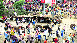 People throw stones on members of another community in the stone war ritual at Devidhura temple in Champawat district on Thursday