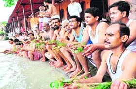 Teerth purohits perform a ritual called Shravani Upkaram in the Ganga on the occasion of Raksha Bandhan at Kushawrat Ghat in Haridwar on Thursday