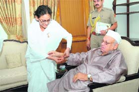 A Brahmkumari ties a rakhi on the wrist of Governor Aziz Qureshi in Dehradun on Thursday