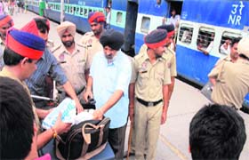 Police personnel check bags of passengers at the railway station in Jalandhar on Thursday