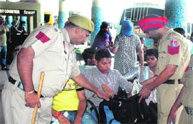 Police personnel check bags of passengers at the bus stand in Jalandhar on Thursday