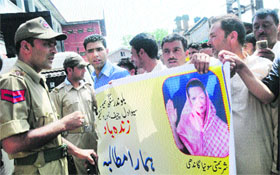 Policemen stop activists of the Congress Sewa Dal from taking out a protest against corruption in Srinagar on Thursday.