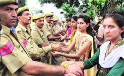 Girls tie rakhis on the wrists of jail staff members in Jammu on Thursday. A Tribune photograph