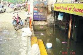 Officials of the health department collect samples of  sewage water collected outside the ship in Ludhiana on Thursday