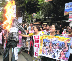 Members of the All-India Progressive Women Association burn an effigy during a protest against alleged torturing of women in West Bengal.