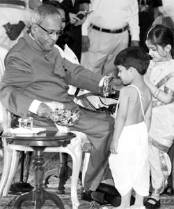 President Pranab Mukherjee celebrates Raksha Bandhan with children at Rashtrapati Bhawan in New Delhi. 