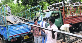 Employees of the MC enforcement wing upload the seized material at Industrial Area, Phase I, Chandigarh, on Friday.