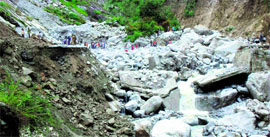 A road that was damaged due to heavy rain in the Lambagarh area of Chamoli district on Friday.