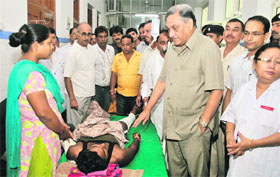 Chief Minister Vijay Bahuguna enquires after the health of a Tyuni mishap victim at Doon Hospital in Dehradun on Friday.