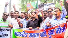 Members of the Bharatiya Janata Yuva Morcha stage a protest against the government in front of the District Magistrate office in Dehradun on Friday.