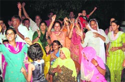 Shooter Vijay Kumars relatives and family members celebrate at his ancestral village Harsour in Hamirpur district after he won the silver medal in the London Olympics on Friday. A Tribune photograph