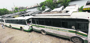 State Road Transport Corporation buses stand in a yard during its employees strike in Jammu on Friday.