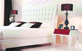 An elegant headboard and subtle contrast lends a plush look