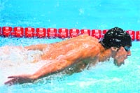 Michael Phelps competes in the men's 100m butterfly on Friday. Phelps won the Gold, his 21st Olympic medal.  AFP 