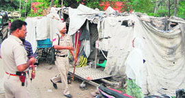 Policemen conduct investigate the murder of a young woman on Batala Road in Amritsar on Saturday.
