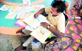 A differently abled man draws a sketch of societys founder Bhagat Puran Singh.