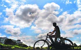 A man rides a cycle under partially cloudy sky in Chandigarh on Saturday