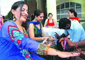 Members of the PCA Club apply mehandi on the occasion of Teej in Mohali on Saturday