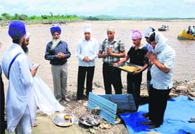 UT employees perform rituals at the Sukhna Lake in Chandigarh on Saturday