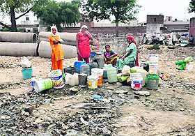 Women queue up for water as its shortage continues in Faridabad on Saturday.