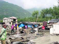 People living close to the Beas try to save their belongings near Manali on Saturday. 