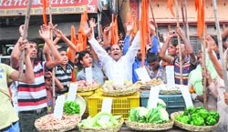 Activists of the Shiv Sena stage a protest against the hike in prices of vegetables in Jammu on Saturday. A Tribune photograph