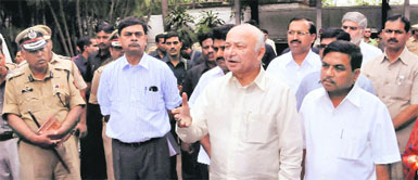 Union Home Minister Sushil Kumar Shinde at the site of blasts in Pune on Saturday. Accompanying him are Maharashtra Home Minister RR Patil (right) and Home Secretary RK Singh (left).