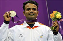Vijay Kumar with the silver medal he won in the mens 25m rapid fire pistol