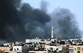 Smoke rises over the Salah al-Din neighbourhood in central Aleppo during clashes between Free Syrian Army fighters and Syrian Army soldiers on Saturday