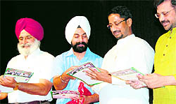 Cabinet minister Anil Joshi releases a souvenir in Amritsar on Sunday