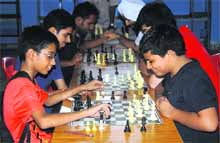 Players make the moves during a chess tournament held at 