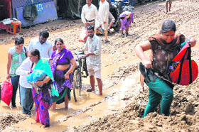 Local people and pilgrims face problems in commuting owing to heavy mud slide and silt accumulation in an inner road in Haridwar on Sunday.