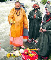 Mahant Deependra Giri performs puja on the banks of the Lidder river at Pahalgam