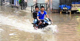 A motorcyclist negotiates his way on a water-filled road in Jalandhar on Sunday morning.