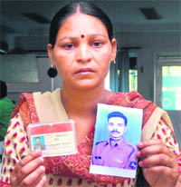 Meenu shows her husband Mukesh Kumars photo in Jalandhar on Saturday.