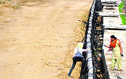 A teacher scales the boundary wall at the expressway on the national highway near Jalandhar bypass.