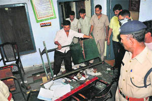 A policeman looks on after a clash between a police officer and train passengers at Moradabad railway police station on Sunday