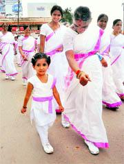 Women participate in Path Sanchalan or Route March on the occasion of Vishwa Samiti Siksha Varga in Hubli on Sunday