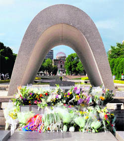 Flowers left by visitors are displayed at the memorial cenotaph for victims of a 1945 atomic bombing at the Peace Memorial Park in Hiroshima on Sunday. Hiroshima will mark the 67th anniversary of the atomic bombing on Monday.