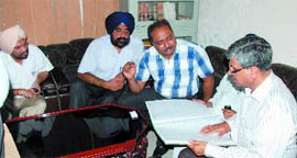 Chief Parlimentary Secretary Sarup Chand Singla inspects the records at the Excise & Taxation office at the Mini-secretariat in Bathinda on Monday.