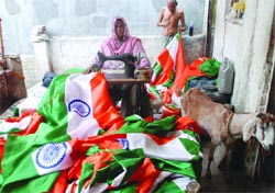 A woman stitching the National Flag ahead of the Independence Day in New Delhi on Monday. Tribune photo: Mukesh Aggarwal
