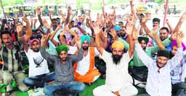 Members of the Punjab Roadways Punbus Contract Workers Union hold a protest in Jalandhar on Monday. 