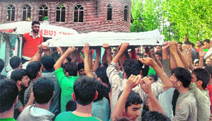 People carry the body of Shabir Ahmad Bhat who was killed in a clash in Ganderbal on Monday. 