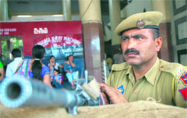 A security guard keeps a vigil at the Jammu railway station. 