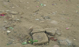 The caved-in portion of the road that was covered with garbage and sand by the MC officials in the Ishar Nagar area of Ludhiana on Monday. 