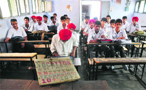 Students of classes XI and XII share a classroom at a government school in Jawahar Nagar, Ludhiana.